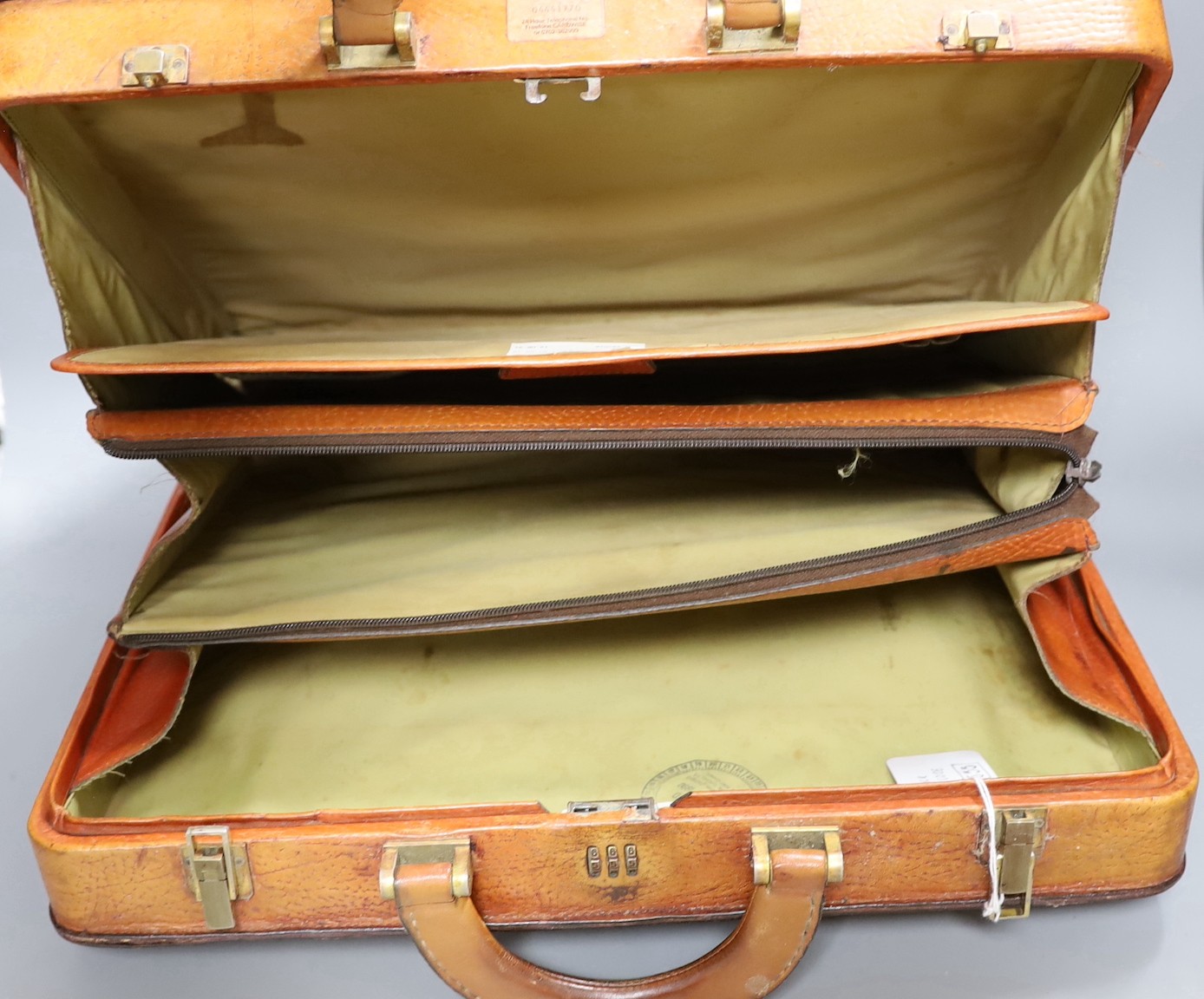 A vintage brown leather briefcase with integrated lock system, together with another Italian Giovanni briefcase